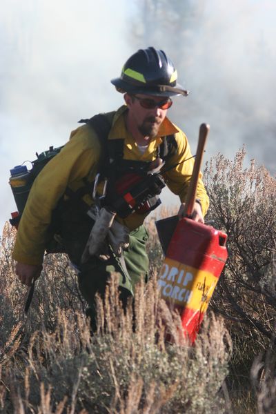 Moving gas cans. Photo by Clint Gilchrist, Pinedale Online.