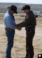 Putting on the handcuffs. Photo by Cat Urbigkit, Pinedale Online.