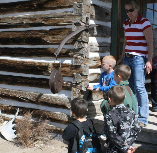 Ringing the dinner bell. Photo by Clint Gilchrist, Pinedale Online.