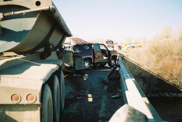 Between rail and semi. Photo by Wyoming Highway Patrol.