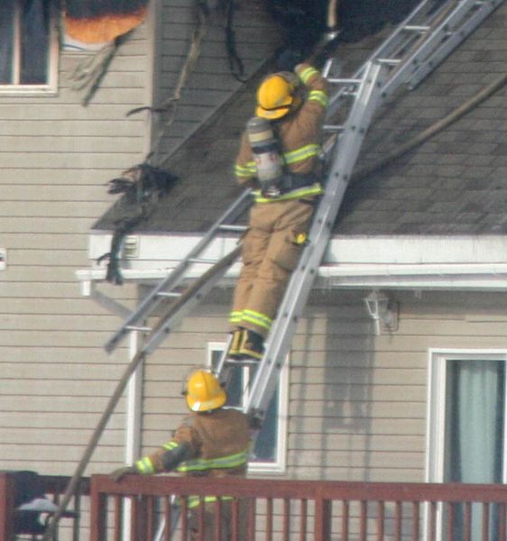 On the ladder. Photo by Clint Gilchrist, Pinedale Online.