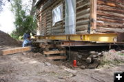 Jacking up the house. Photo by Clint Gilchrist, Pinedale Online.