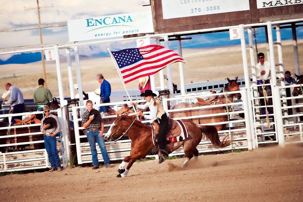 Flag parade. Photo by Tara Bolgiano, Blushing Crow Photography.