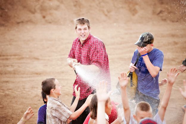 Getting sprayed. Photo by Tara Bolgiano, Blushing Crow Photography.