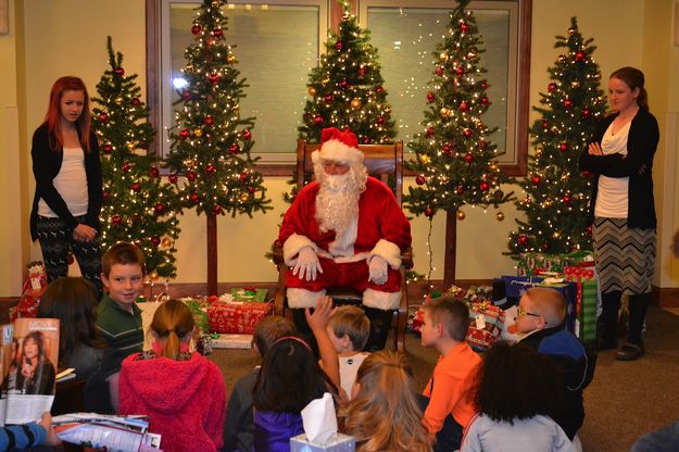 Santa hands out gifts. Photo by Carla Sullivan.