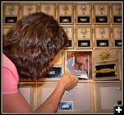 Maria Places Mail in Judy's Box. Photo by Terry Allen.