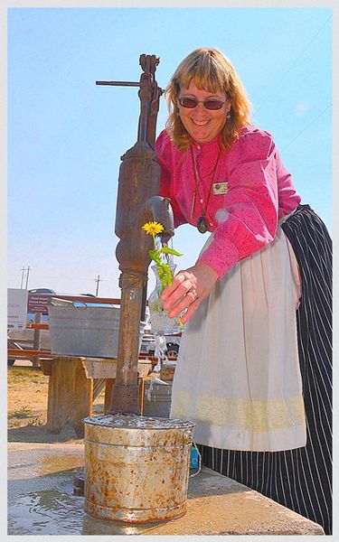 Dawn Watering Flowers. Photo by Terry Allen.