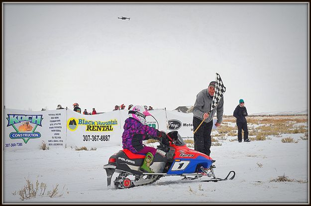 Koral Gets the Checkered Flag. Photo by Terry Allen.