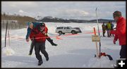 Darren Carries Gabe Across Finish. Photo by Terry Allen.