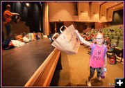 Hannah Grabs Her Costume Bag. Photo by Terry Allen.