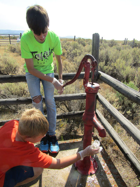 Getting a water sample. Photo by Dawn Ballou, Pinedale Online.